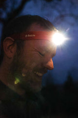 BioLite HeadLamp 425 in Ember Yellow being worn by a man outside.