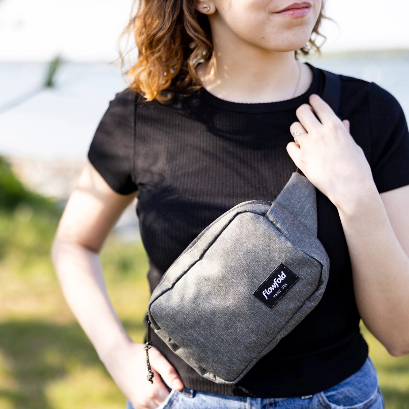 Flowfold Explorer Pack Small, made in the USA, worn by a person as a crossbody bag.