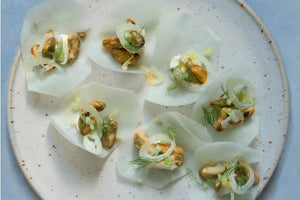 Plated dish of Fangst Limfjord Blue Mussels in Dill & Fennel with a light background