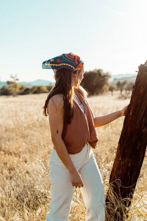 Bandits Bandana Endless Bloom bandana being worn by a woman outdoors.