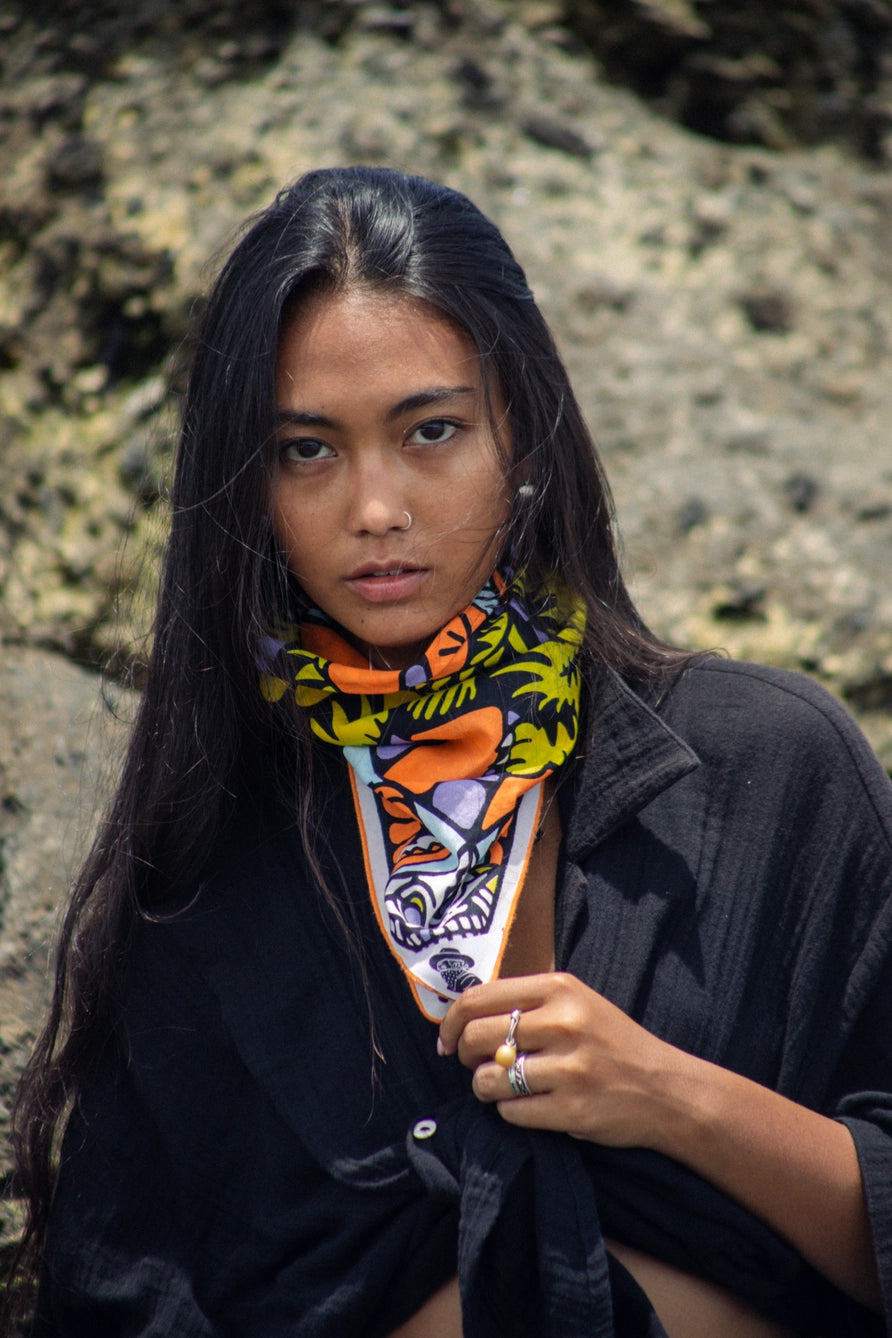 Bandits Bandana Trapped In bandana being worn by a woman on the beach.