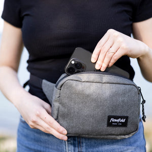 Flowfold Explorer Pack Small, made in the USA, worn by a person to store a cellphone.