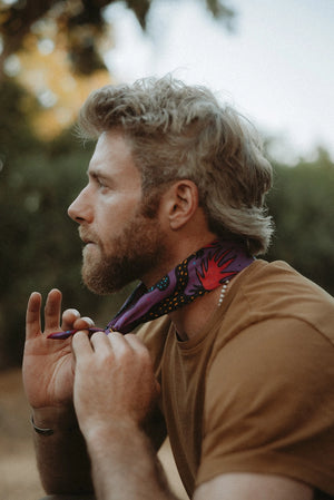 Bandits Electric Desert Parade bandana worn by a man outdoors.