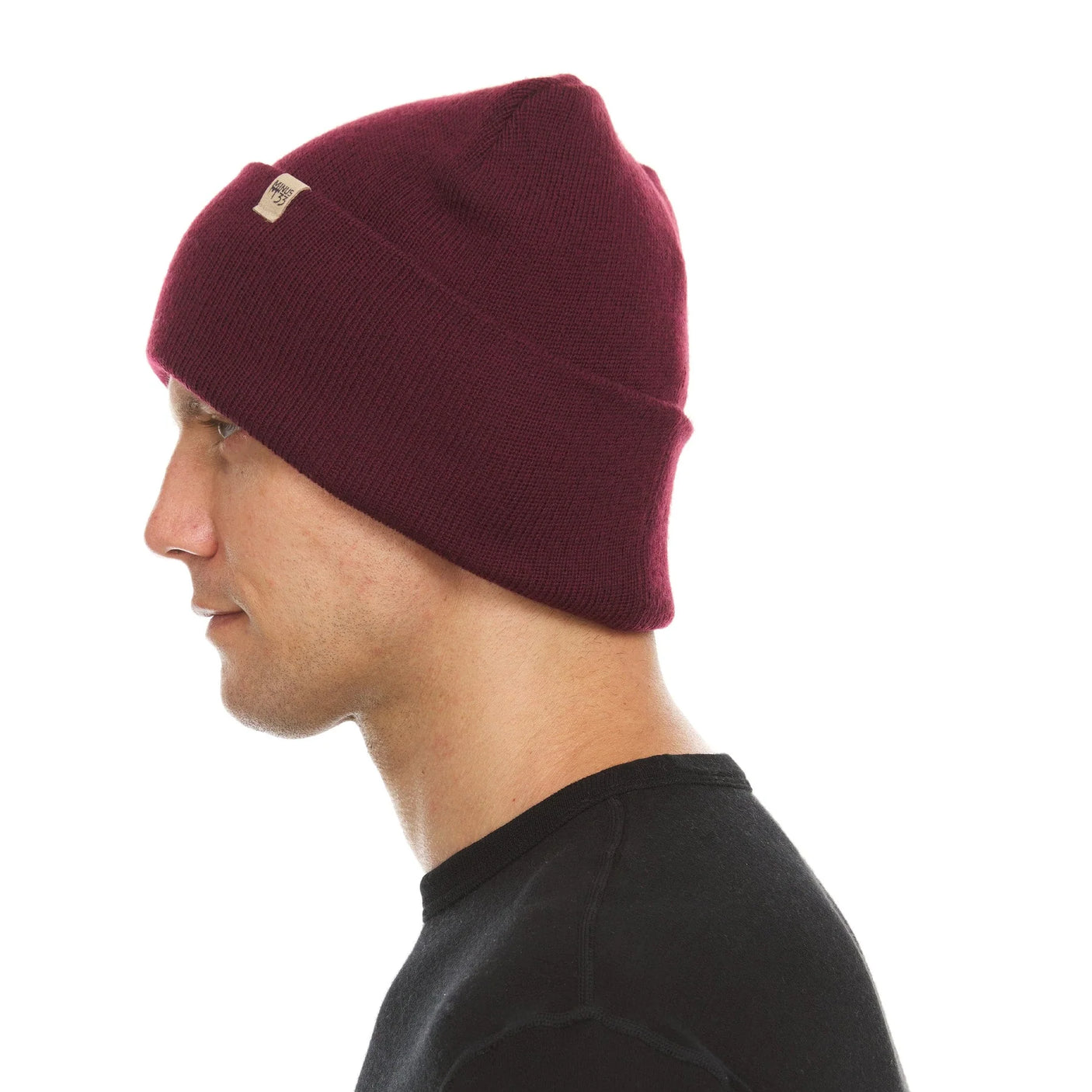 Minus33 Everyday Knit Cuff Merino Wool Beanie worn by a man and viewed from the side.