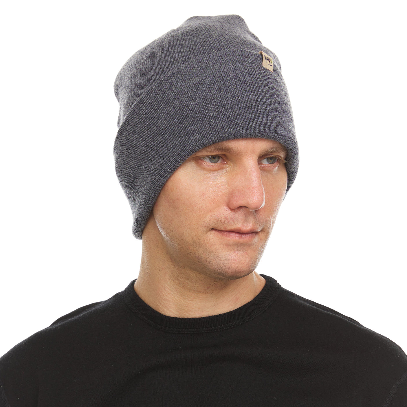 Minus33 Everyday Knit Cuff Merino Wool Beanie in Charcoal Gray being worn on a neutral background.