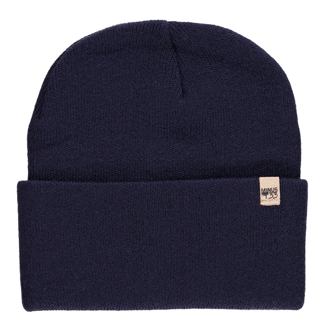 Minus33 Everyday Knit Cuff Merino Wool Beanie in Navy on a neutral background.