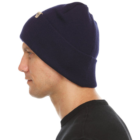 Minus33 Everyday Knit Cuff Merino Wool Beanie in Navy being worn on a neutral background.