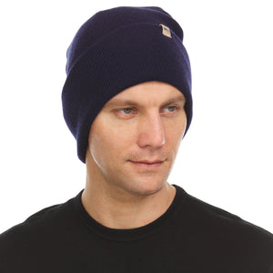 Minus33 Everyday Knit Cuff Merino Wool Beanie in Navy being worn on a neutral background.