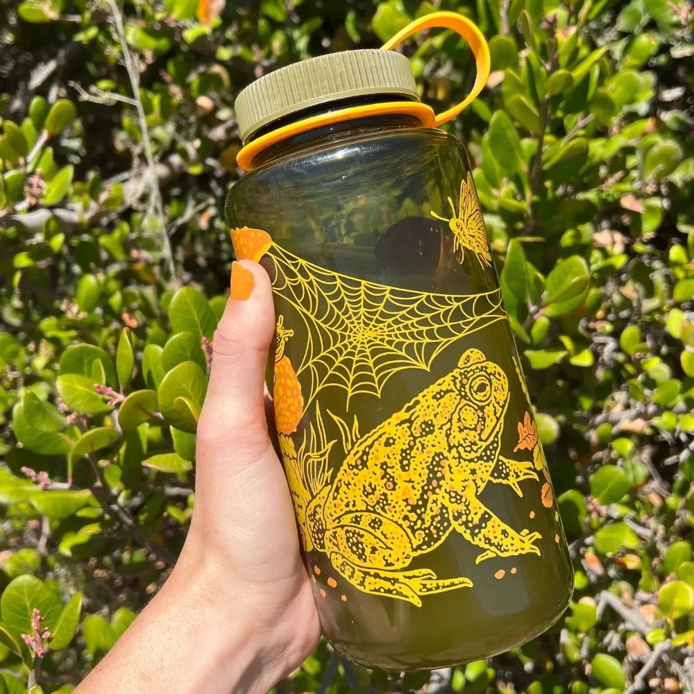 Mustard Beetle 32oz Nalgene bottle with the Toad & Mushrooms print features an orange and yellow print on a brown Nalgene bottle.