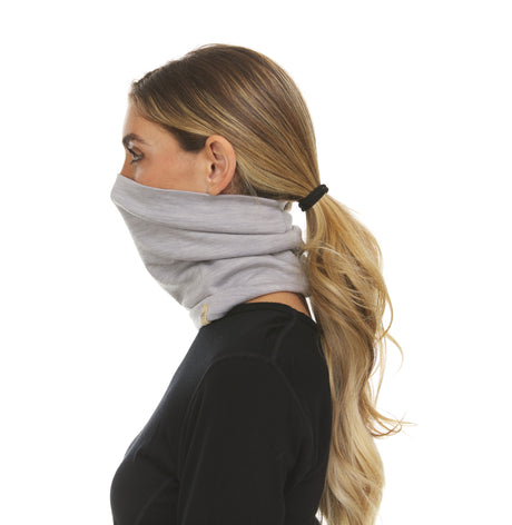 Minus33 Midweight Merino Wool Neck Gaiter worn by a woman and viewed from the side.