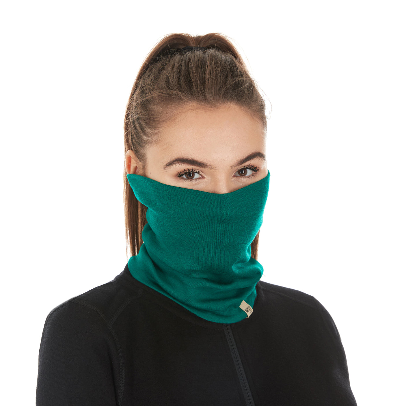 Minus33 Midweight - Neck Gaiter 100% Merino Wool in Emerald Green worn on a neutral background.