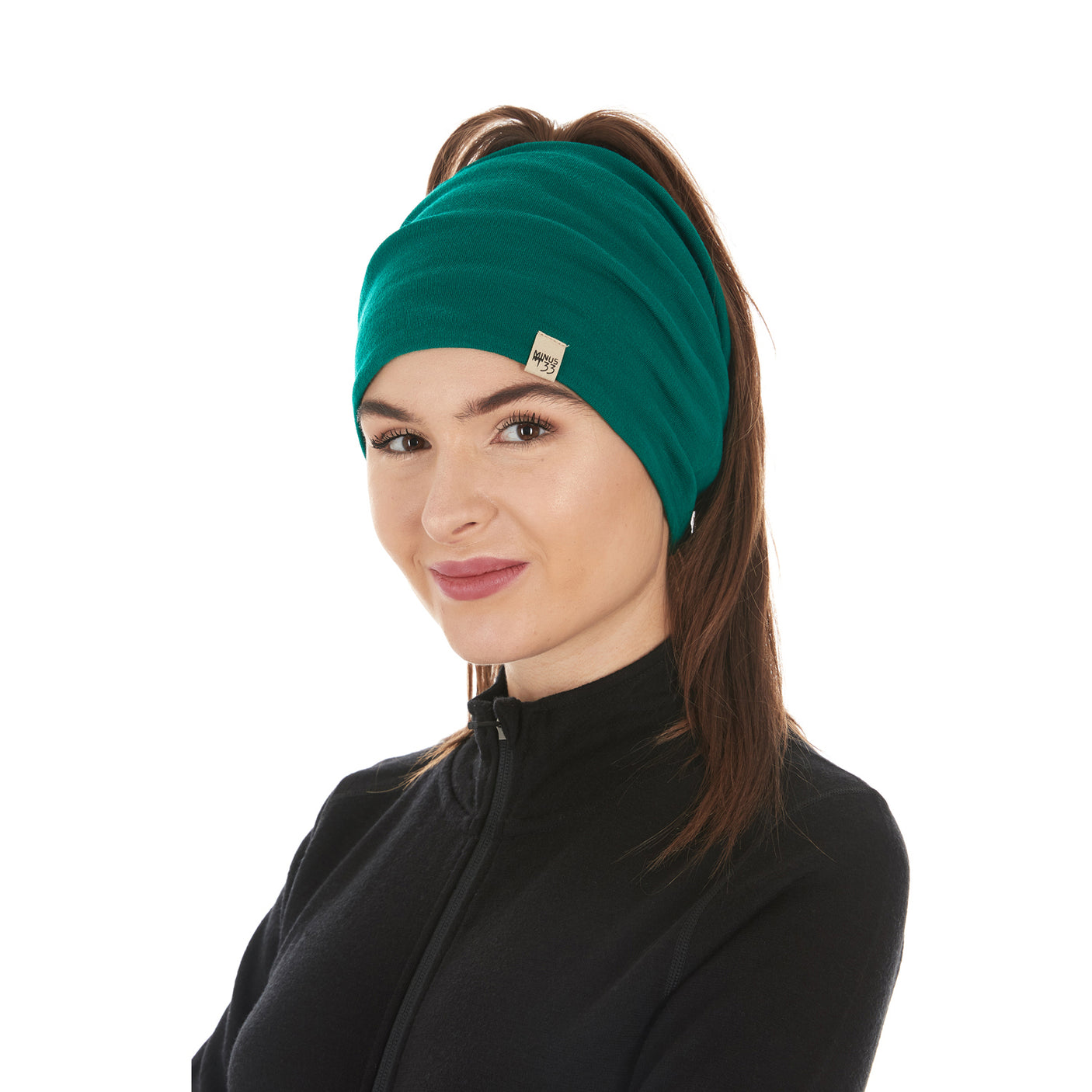 Minus33 Midweight - Neck Gaiter 100% Merino Wool in Emerald Green worn on a neutral background.