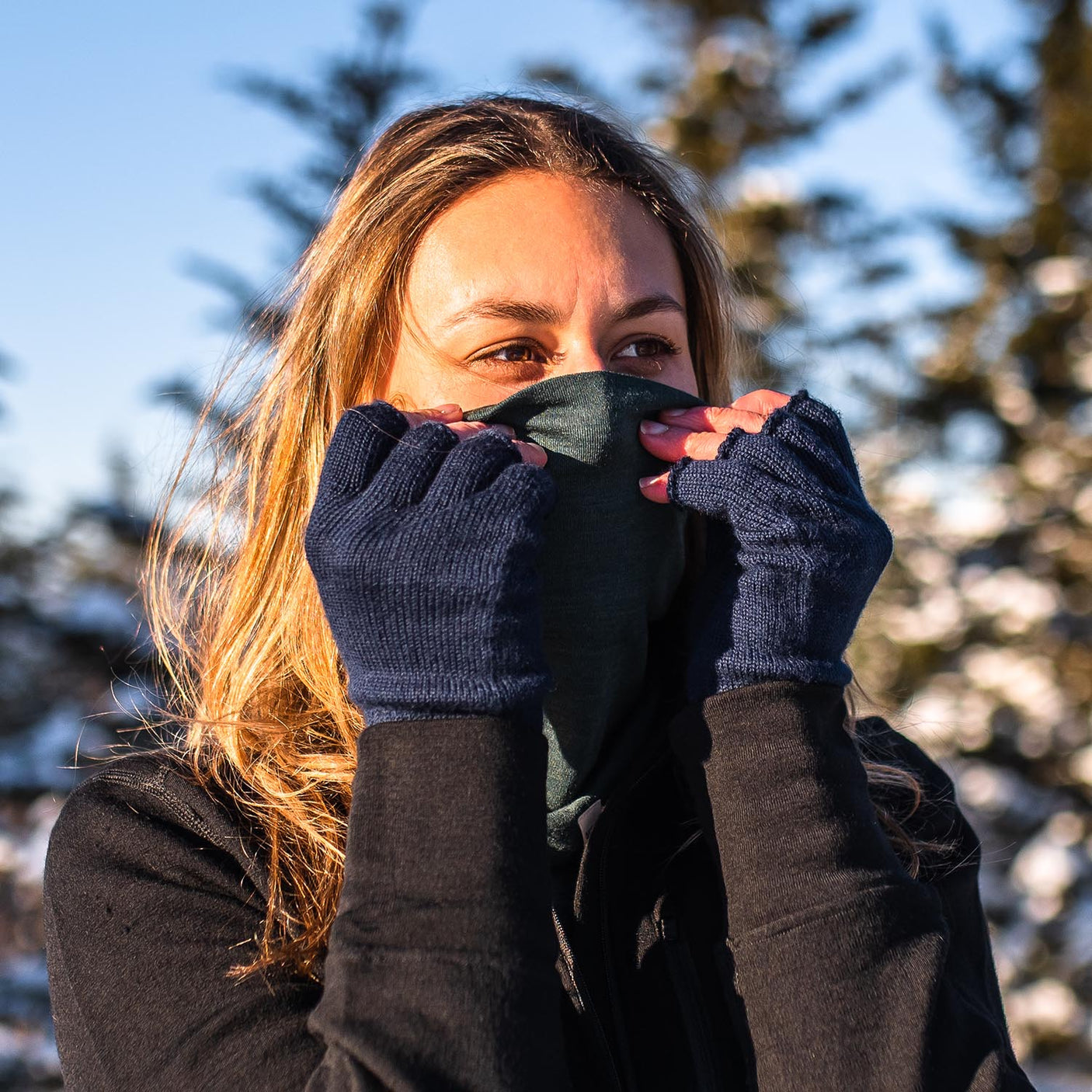 Minus33 Midweight Merino Wool Neck Gaiter worn by a woman outdoors in the cold.