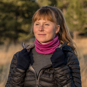 Minus33 Midweight - Neck Gaiter 100% Merino Wool in Radiant Violet being worn by a woman outdoors.