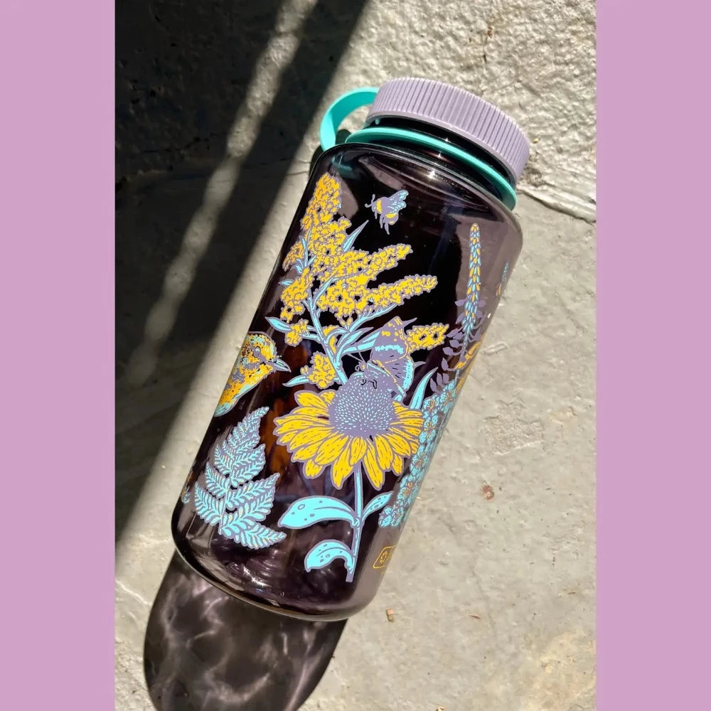 Mustard Beetle 32oz Nalgene bottle with the Prairie Warbler design, featuring a bird and flowers on a lavender colored Nalgene bottle.