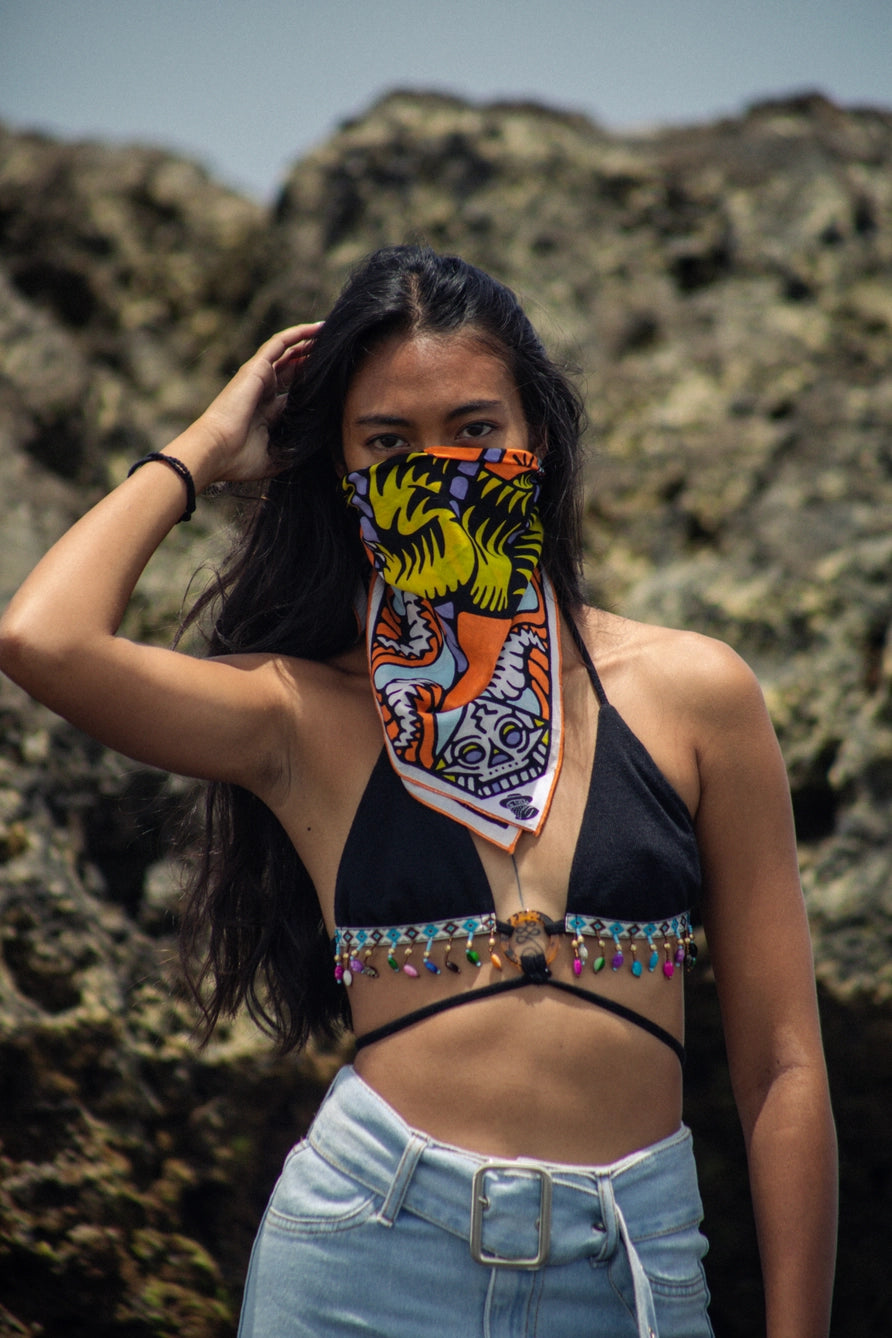 Bandits Bandana Trapped In bandana being worn by a woman on the beach.