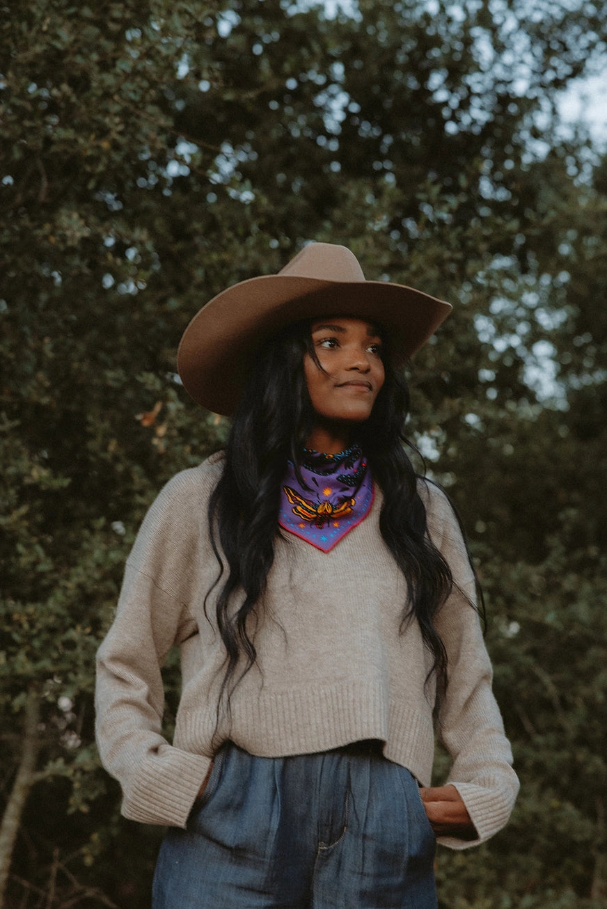 Bandits Electric Desert Parade bandana worn by a woman outdoors.