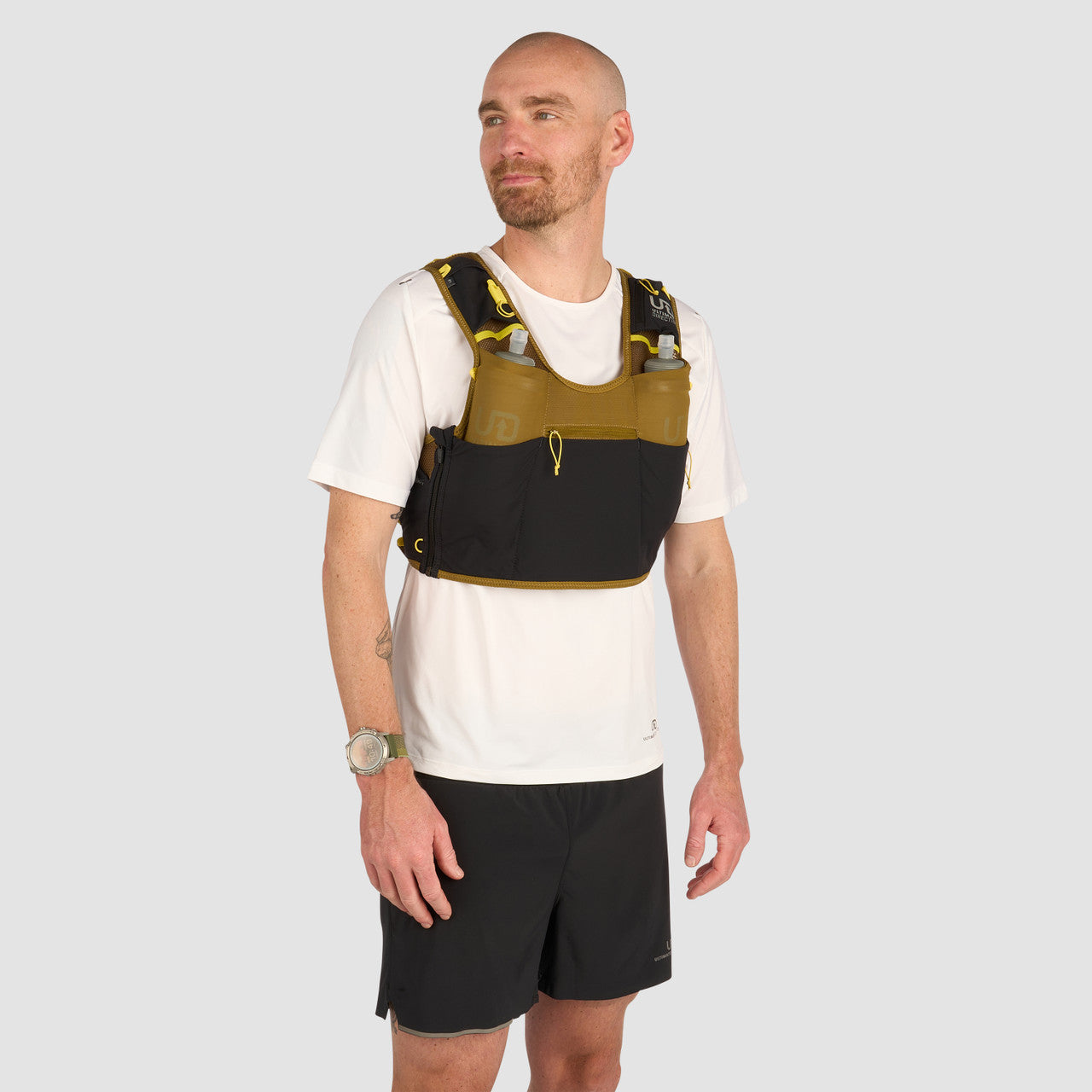 Ultimate Direction Xodus Vest in Fig Green being worn from the front on a neutral background.