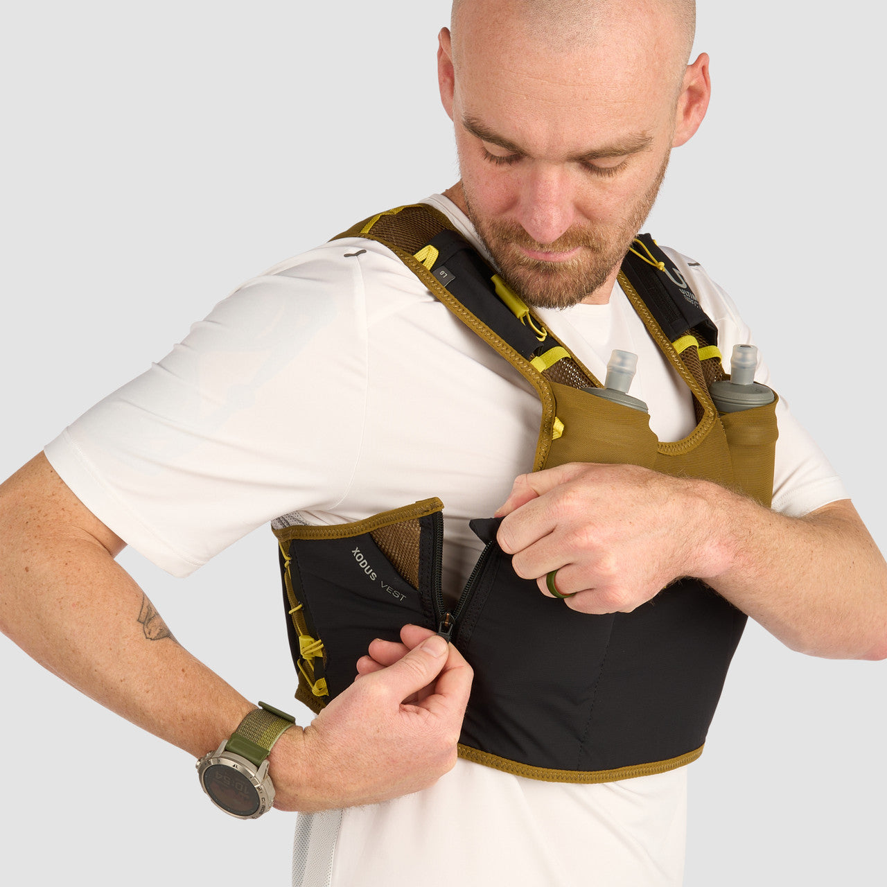 Ultimate Direction Xodus Vest in Fig Green being worn from the side on a neutral background.