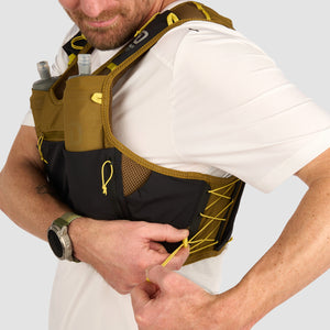 Ultimate Direction Xodus Vest in Fig Green being worn from the side on a neutral background.