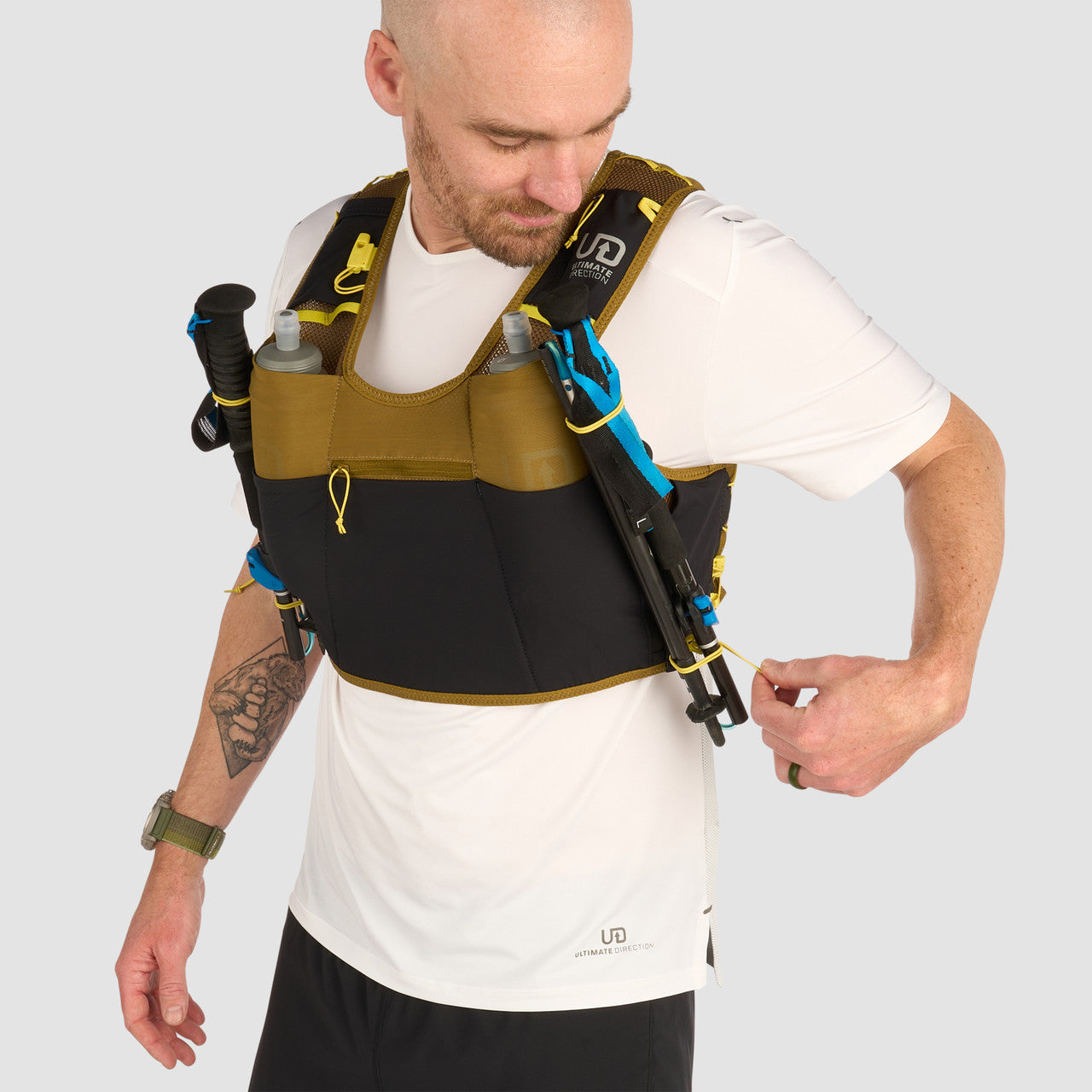 Ultimate Direction Xodus Vest in Fig Green being worn from the front on a neutral background.