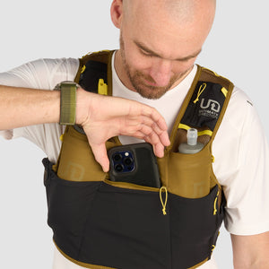 Ultimate Direction Xodus Vest in Fig Green being worn from the front on a neutral background.