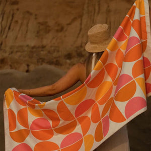 Trek Light Half Moon Wander towel is made from recycled plastic bottles and features a colorful half moon pattern.