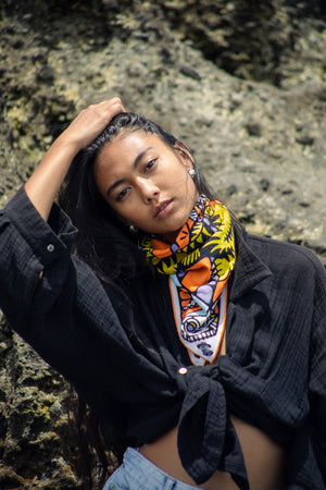 Bandits Bandana Trapped In bandana being worn by a woman on the beach.