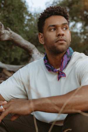 Bandits Electric Desert Parade bandana worn by a man outdoors.