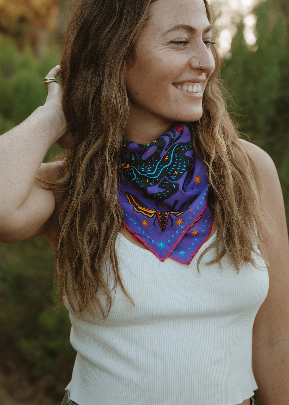 Bandits Electric Desert Parade bandana worn by a woman outdoors.