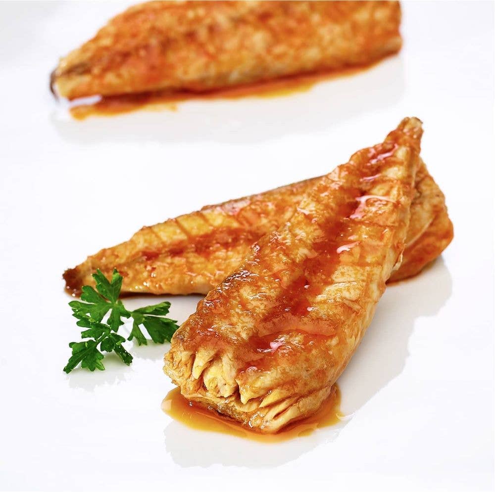 La Narval Mackerel Fillets in Tomato Sauce on a white plate with a sprig of parsley