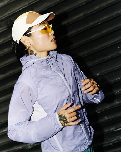 Ciele Athletics W VNTJacket women's running jacket in Light Grape worn by a woman runner outdoors.
