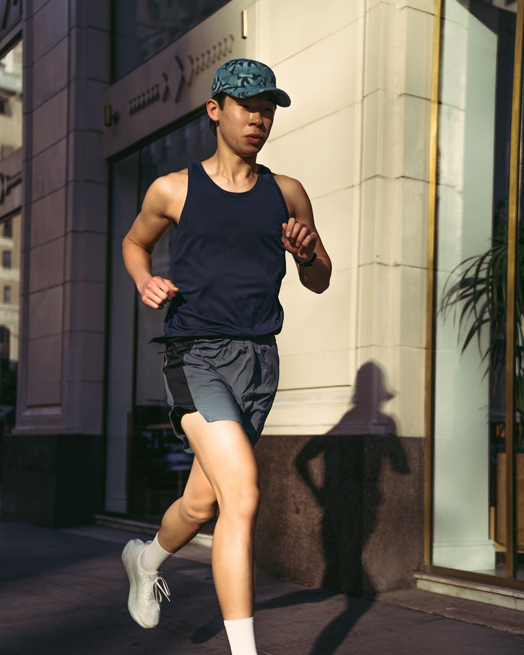 Ciele Athletics GOCap SC Field Loopy MU running hat in Dusty Turquoise worn by a runner outdoors.