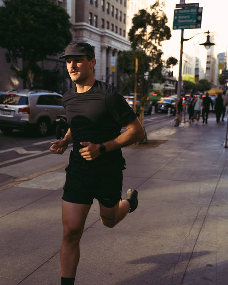 Ciele Athletics M FSTTShirt men's running shirt in Shadowcast worn by a man running outdoors.