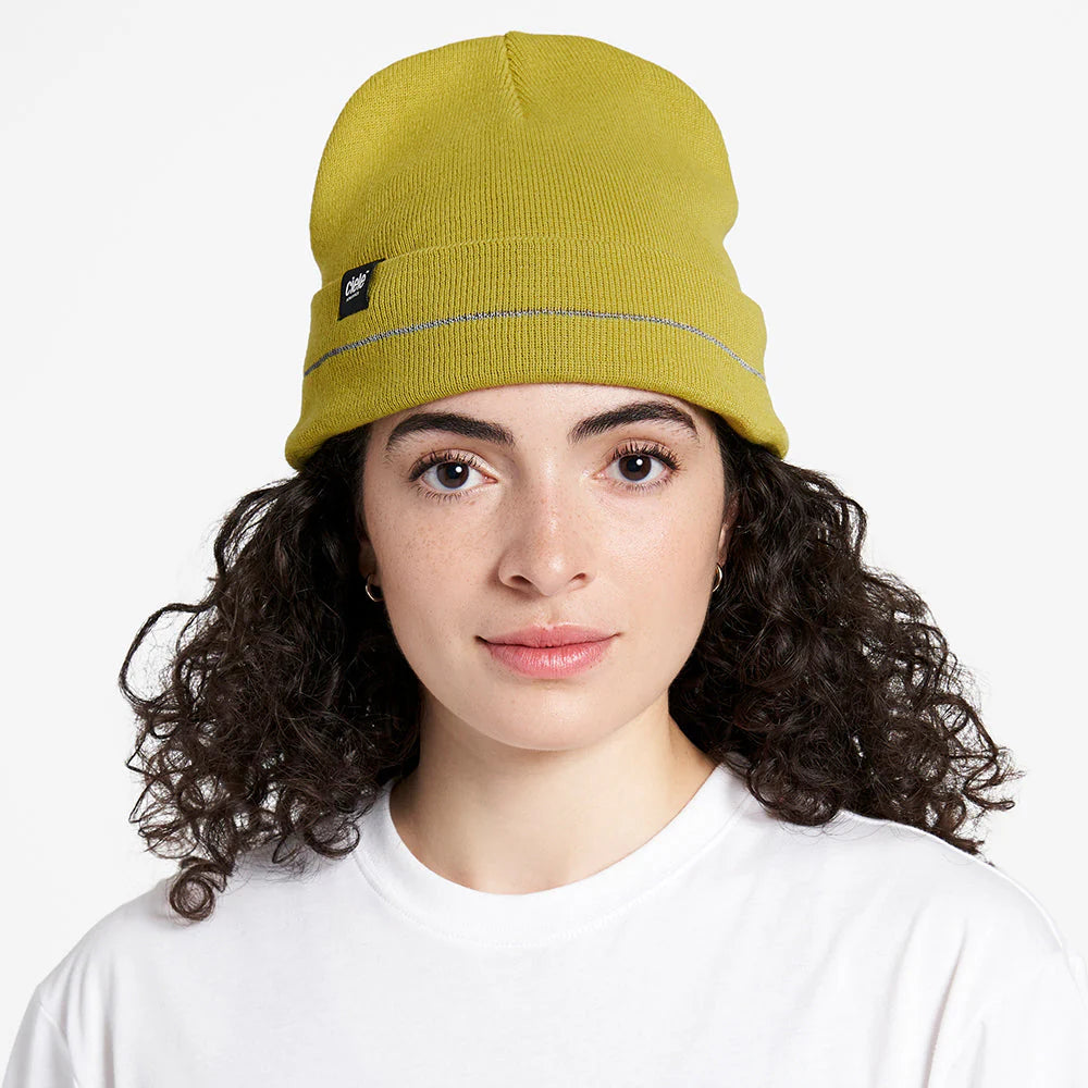 Ciele Athletics CR3Beanie trail running beanie in Sogl worn by a woman on a neutral background.