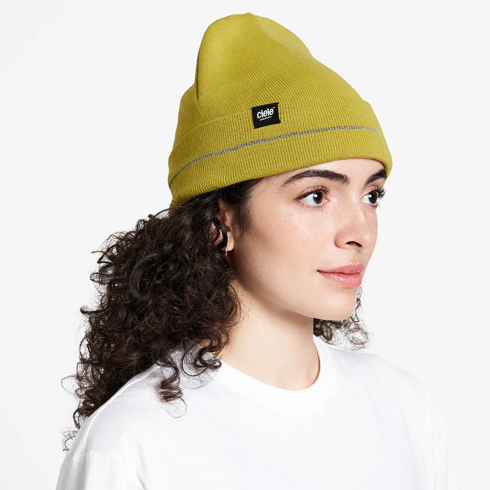 Ciele Athletics CR3Beanie trail running beanie in Sogl worn by a woman from the side on a neutral background.