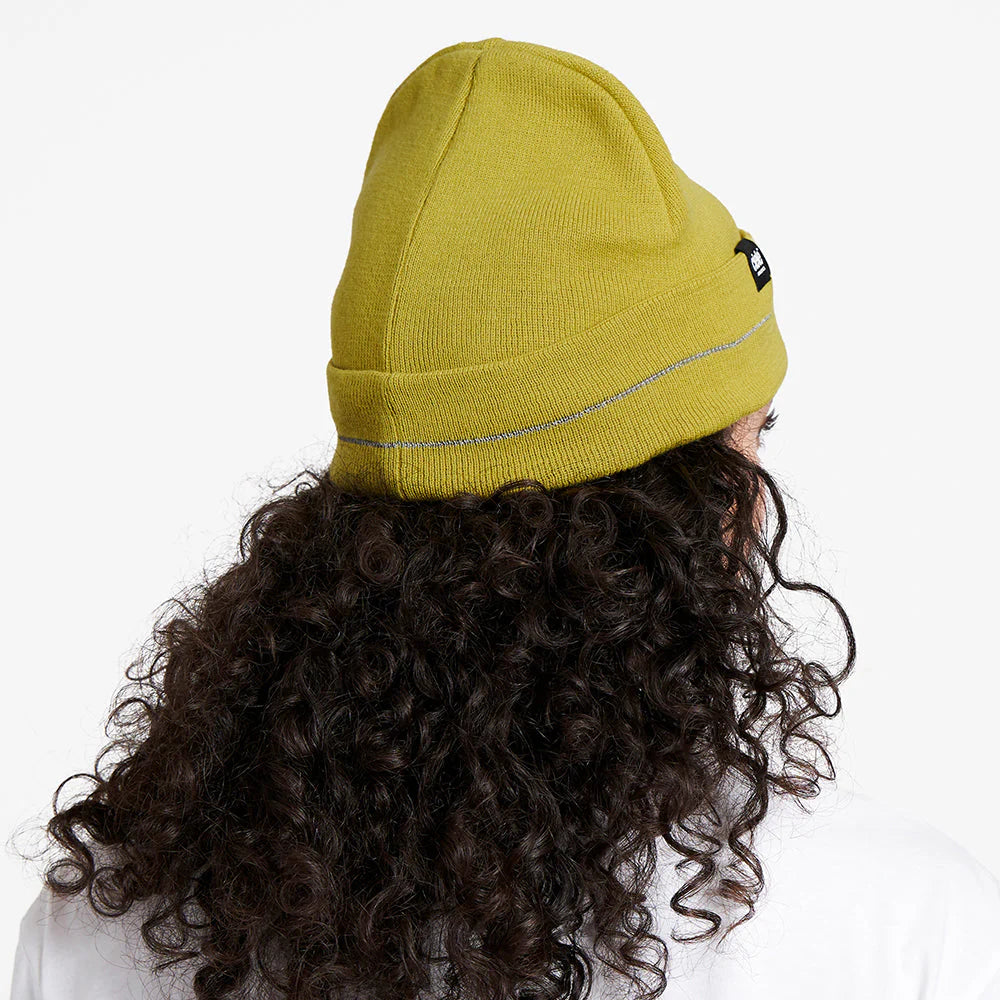 Ciele Athletics CR3Beanie trail running beanie in Sogl worn by a woman from the rear on a neutral background.
