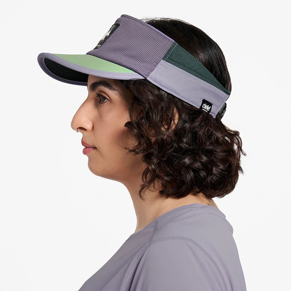Ciele Athletics TRLVisor SC Trail - Range cuts in Stormtaker worn by a woman from the side on a neutral background.