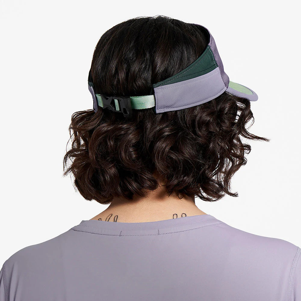 Ciele Athletics TRLVisor SC Trail - Range cuts in Stormtaker worn by a woman from the rear on a neutral background.