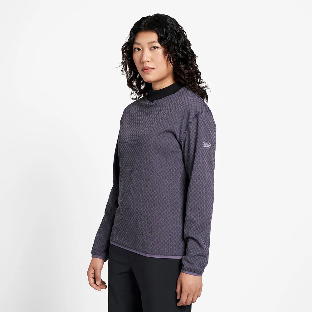 Ciele Athletics Unisex VLVMockneck cold weather running sweatshirt in Astronautic worn by a woman from the side on a neutral background.