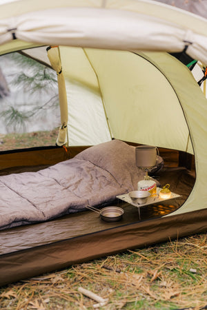Snow Peak LiteMax Titanium Stove on a camping background.
