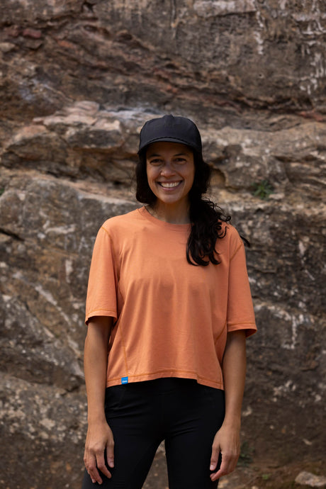 Janji's Circa Boxy Daily Tee in Amphora being worn by a woman outdoors.