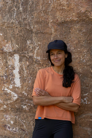 Janji's Circa Boxy Daily Tee in Amphora being worn by a woman outdoors.