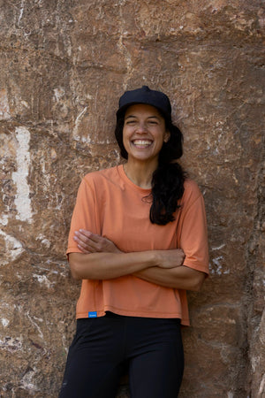 Janji's Circa Boxy Daily Tee in Amphora being worn by a woman outdoors.