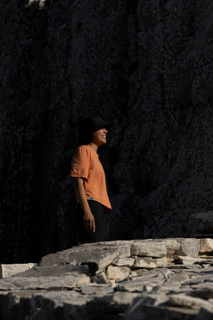 Janji's Circa Boxy Daily Tee in Amphora being worn by a woman outdoors.