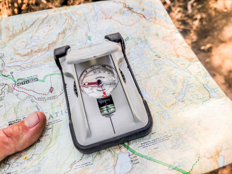 Brunton TruArc 20 Luminous Compass being used outdoors with a map.