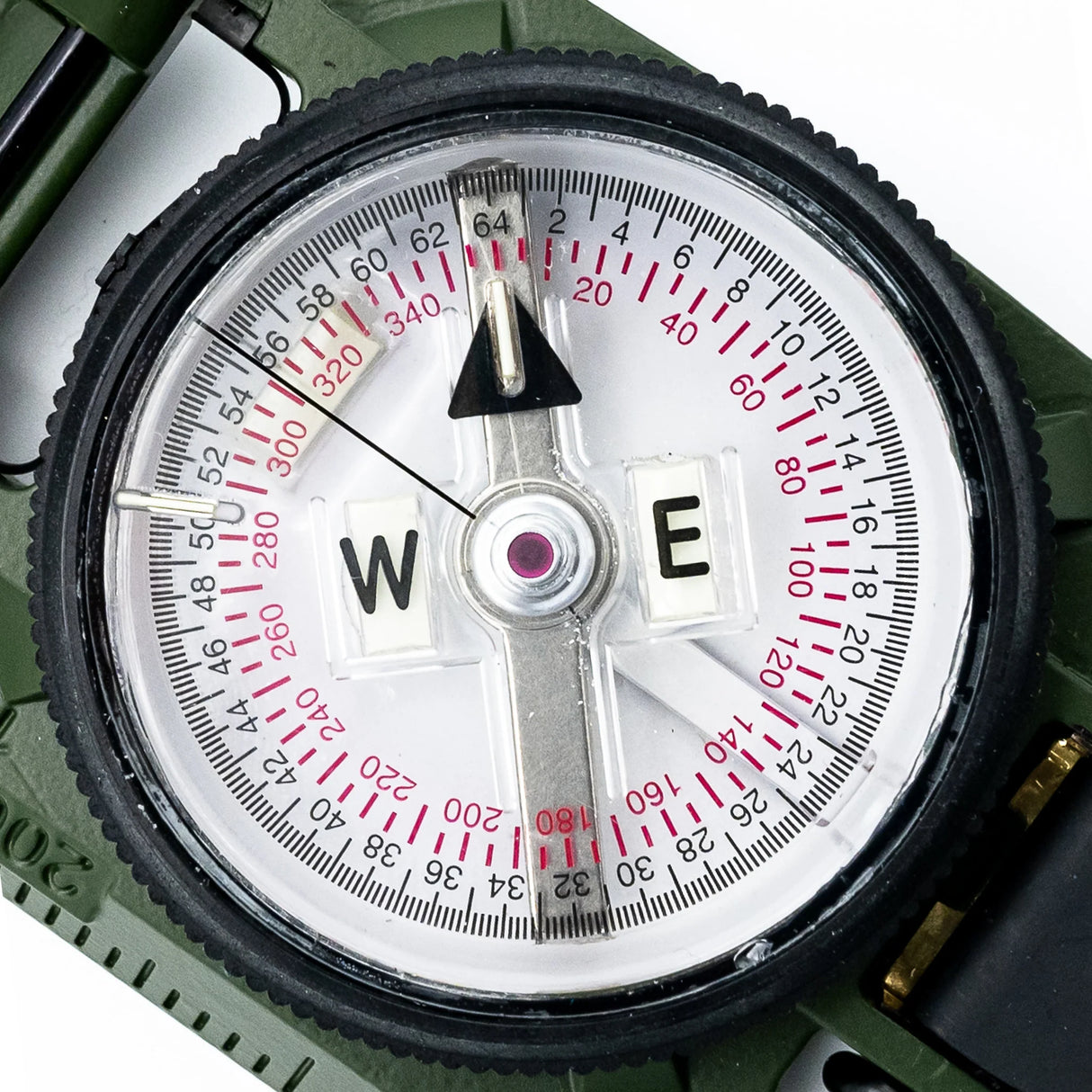 Close-up of a Brunton H-3 Tritium Lensatic Compass with a white face and black rim on a green background