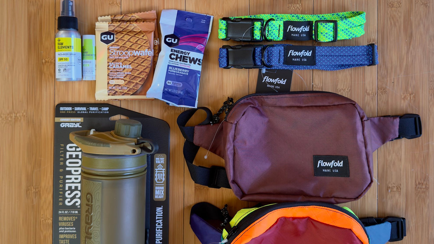 Selection of new, sustainable outdoor gear against a neutral wood background.