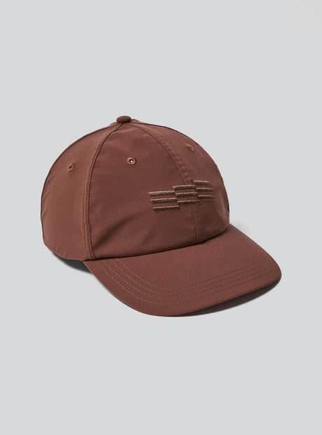 Janji Omni Undercover Cap in Goji on a neutral background.