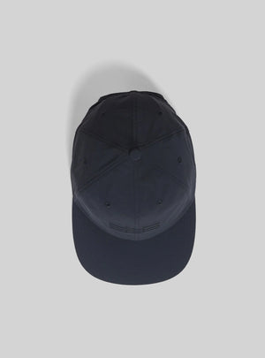 Janji Omni Undercover Cap in Midnight on a neutral background.